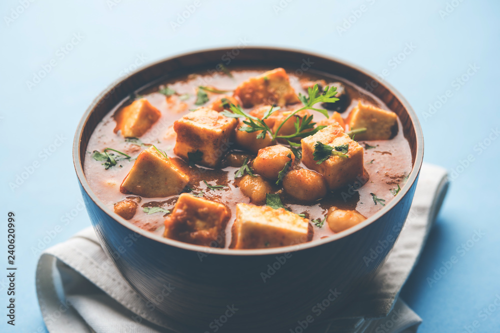 Chole Paneer curry made using boiled chickpea with cottage cheese with spices. Popular North Indian recipe. served in a bowl or serving pan. Selective focus