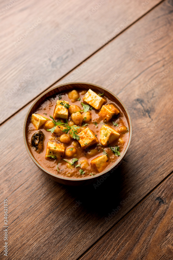 Chole Paneer curry made using boiled chickpea with cottage cheese with spices. Popular North Indian recipe. served in a bowl or serving pan. Selective focus Chole Paneer curry made using boiled chickpea with cottage cheese with spices. Popular North Indian recipe. served in a bowl or serving pan. Selective focus
