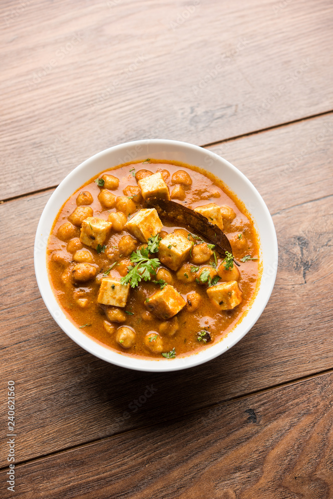 Chole Paneer curry made using boiled chickpea with cottage cheese with spices. Popular North Indian recipe. served in a bowl or serving pan. Selective focus