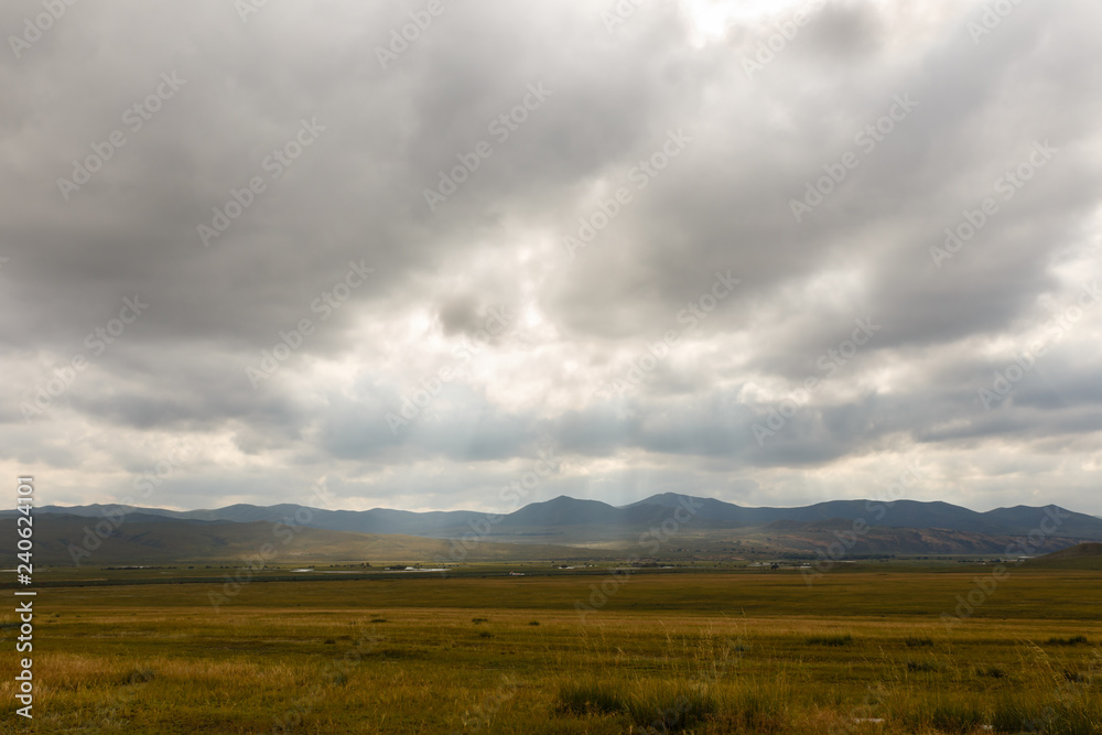Mongolian steppe, beautiful landscape with cloudy sky.