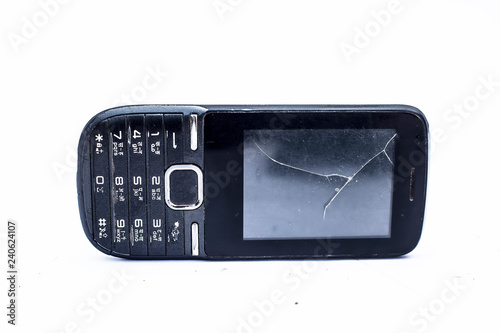 Close up of black colored cell phone with switches or keys on it isolated on white.