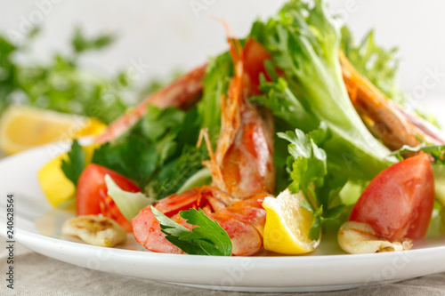 fresh salad with grilled shrimps with spices and tomatoes