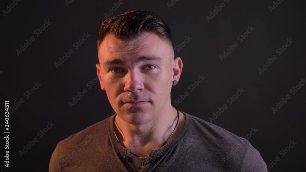 Closeup portrait of attractive caucasian man looking at camera and nodding . Approval expression Closeup portrait of attractive caucasian man looking at camera and nodding . Approval expression