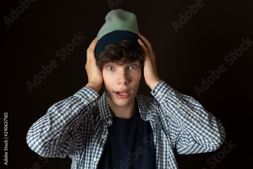 young man in casual portrait surprised emotion, exited isolated on dark background f
