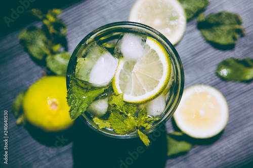 Mojito or fresh lemonade drink with green lime and mint
