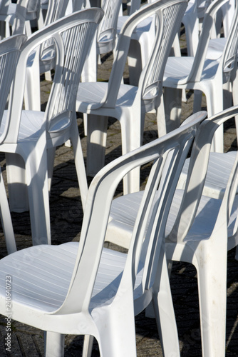 Composition with white chairs in outdoor auditorium