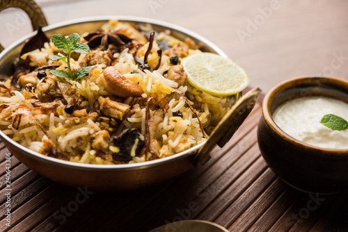 Keema or Kheema Biryani - Fragrant and spicy minced lamb or goat or chicken cooked in range of aromatic spices with basmati rice. served in a karahi with curd. selective focus photo