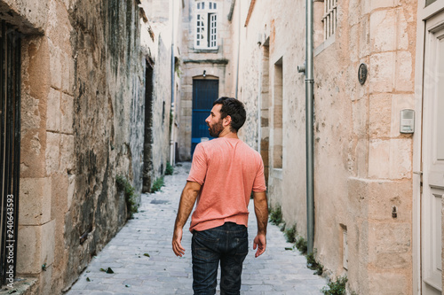 .Young man doing sightseeing around the beautiful city of Bordeaux in France. Feeling free and happy discovering new places. Travel photography. © lubero