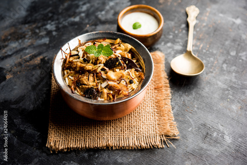 Keema or Kheema Biryani - Fragrant and spicy minced lamb or goat or chicken cooked in range of aromatic spices with basmati rice. served in a karahi with curd. selective focus photo