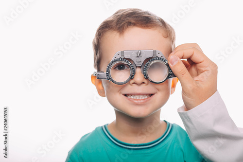 little patient receiving eye exam and smiling