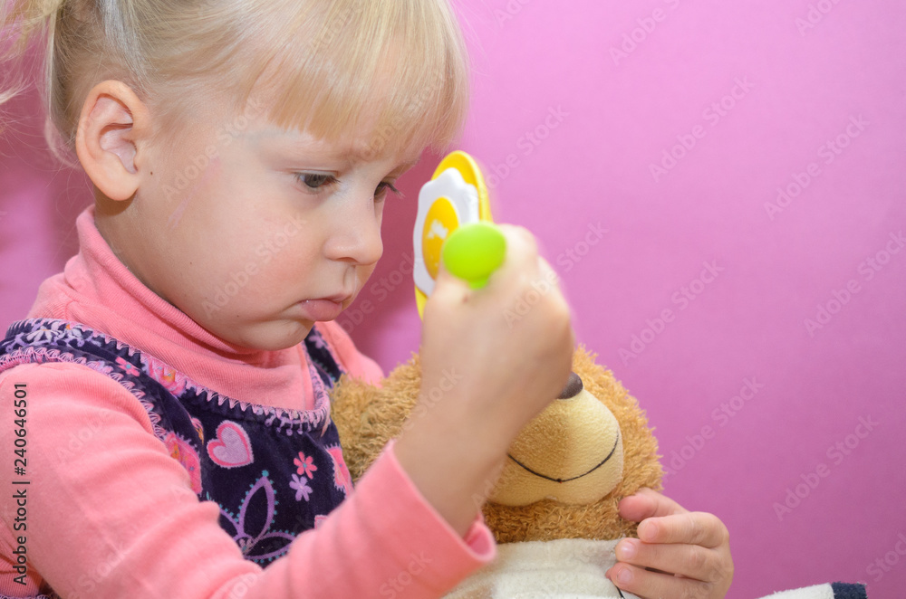 The little girl is playing with any soft toys. The little girl is playing with any soft toys.