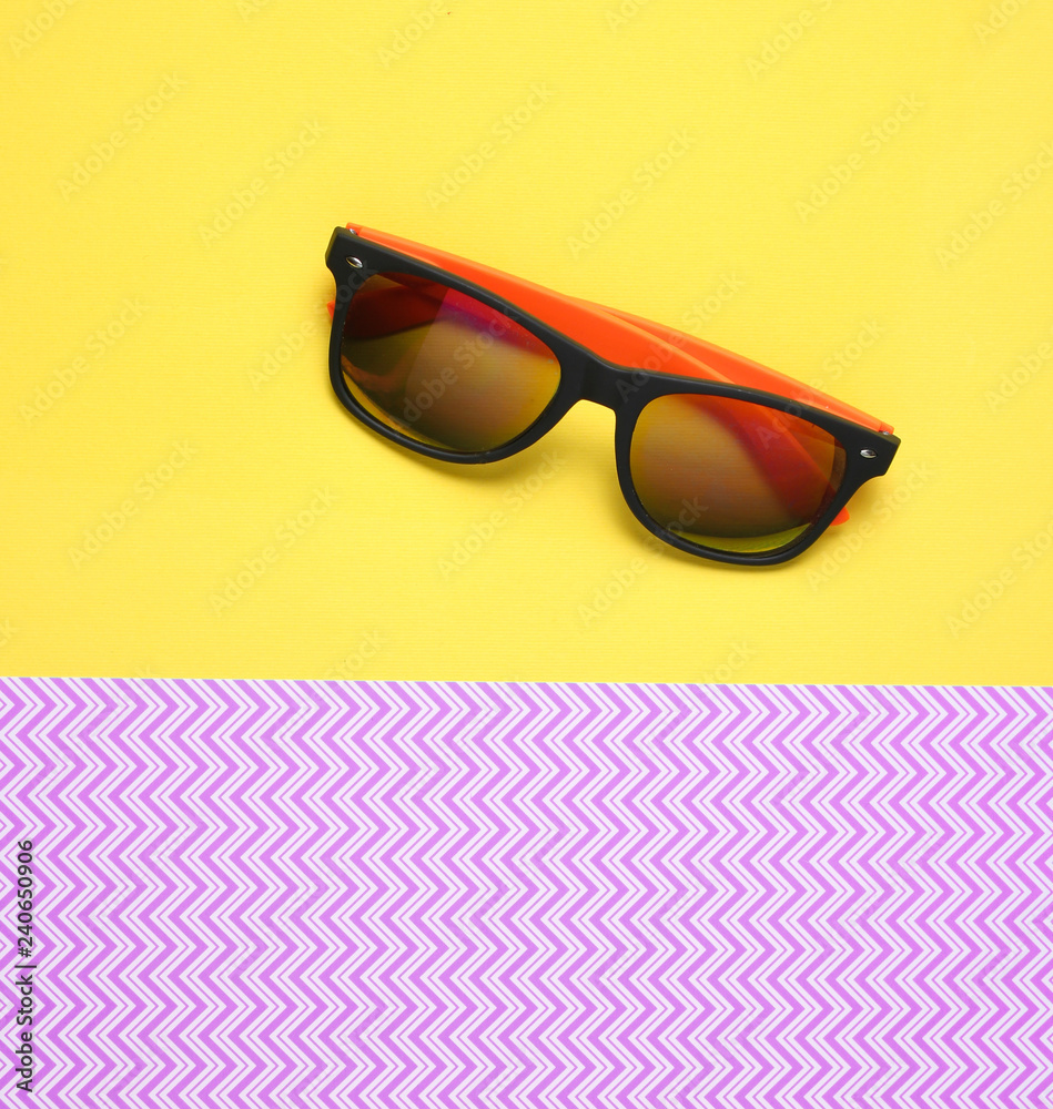 Sunglasses on a creative purple yellow background, summertime, minimalism, top view. Sunglasses on a creative purple yellow background, summertime, minimalism, top view.