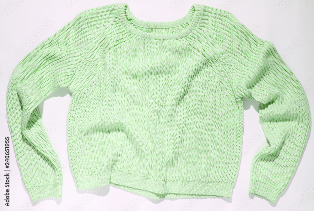 green sweater on a white background, top view.