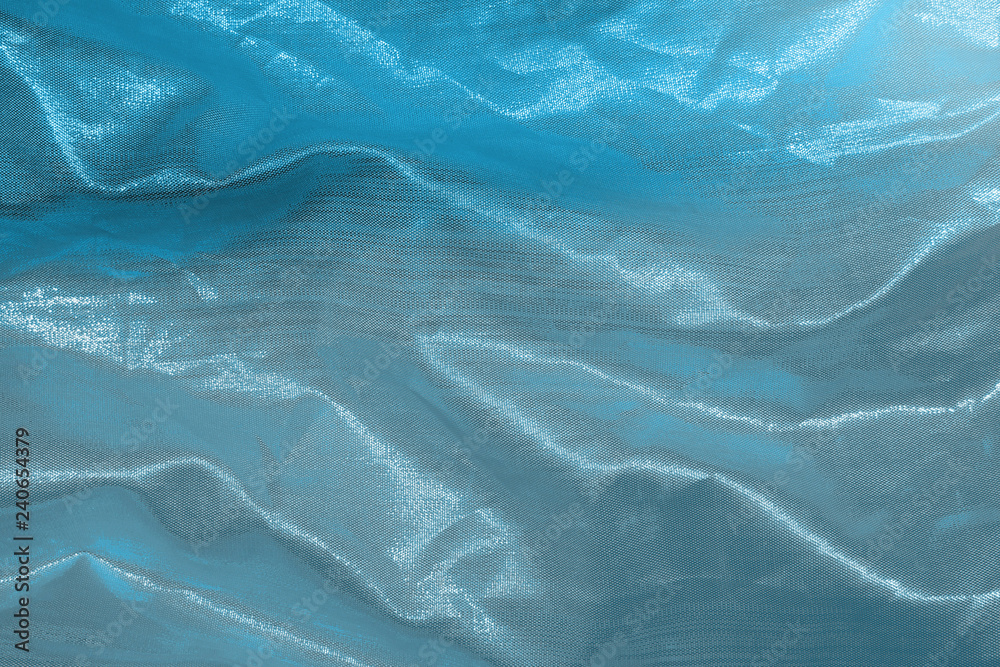 Obraz premium Ocean blue textile background. Silk cloth texture. Fabric jeans pattern.