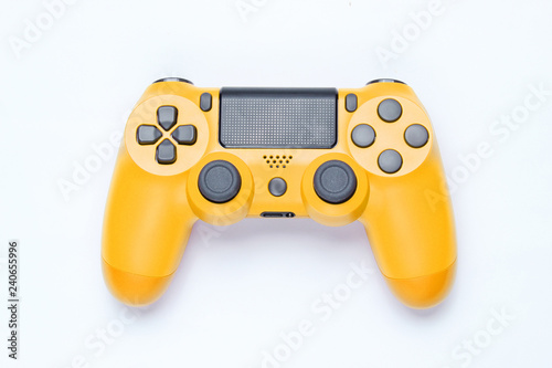 Modern yellow gamepad (joystick) on gray background. Top view.