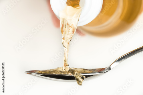 Pouring Rice Vinegar on a Spoon photo