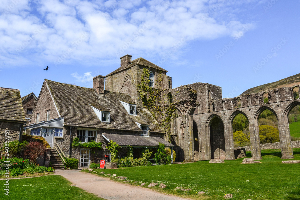 Landmarks of Wales travel concept. View of ancient ruins of the castle/church in Brecon Beacons National Park, United Kingdom. Popular tourist attraction (Llanthony Priory,Hay-on-Wye, Black Mountains) Landmarks of Wales travel concept. View of ancient ruins of the castle/church in Brecon Beacons National Park, United Kingdom. Popular tourist attraction (Llanthony Priory,Hay-on-Wye, Black Mountains)