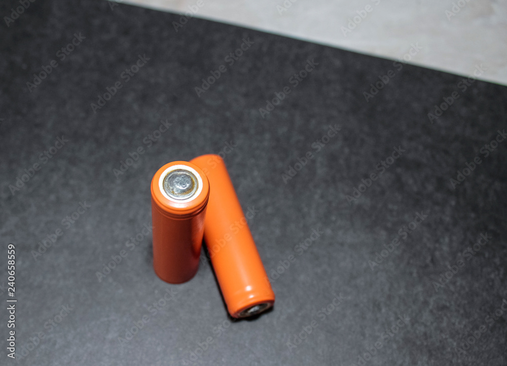 Two AA batteries on a black background. Two AA batteries on a black background.