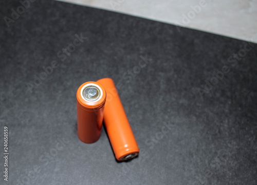 Two AA batteries on a black background. photo