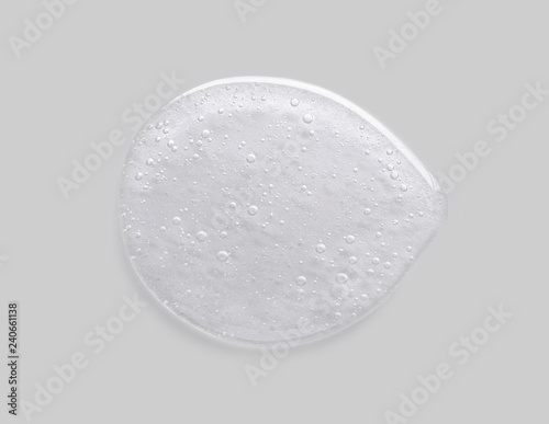 Cosmetic liquid gel collagen serum on grey background.