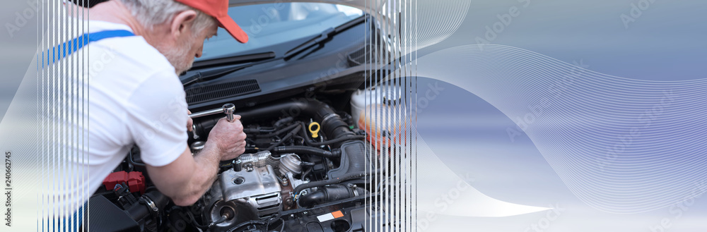 Car mechanic working on car engine. panoramic banner Car mechanic working on car engine. panoramic banner