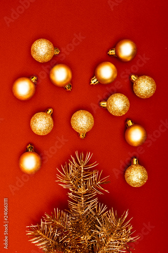 Creative vertical pattern with golden Christmas tree branches and multiple golden baubles.
