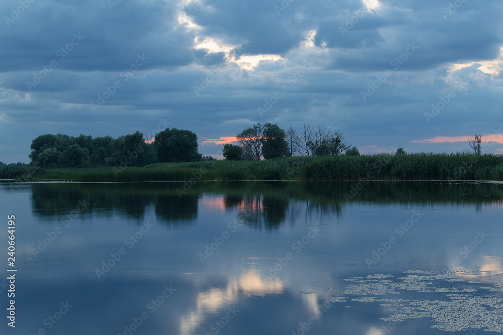 Reflection of clouds in the river at sunset