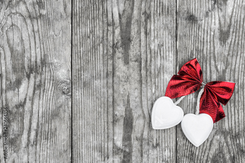 Valentine's Day. Decorative white wooden hearts against an old wooden background.