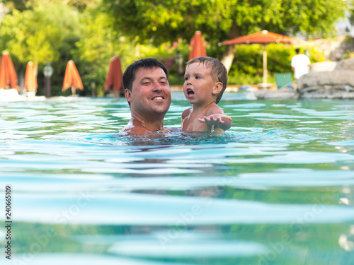 Father and child swimming in the pool © StockBox