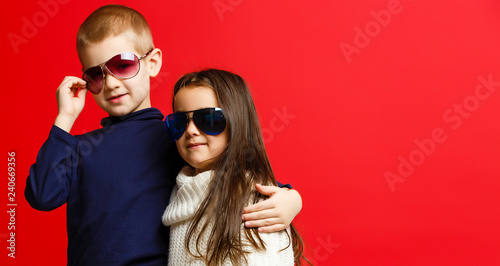 Funny lovely children. fashionable little boy and girl in glasses, jeans, white shirts stylish kids in casual clothes in shocked. fashion children