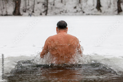 Men Health life style concept. Winter Ice hole swimming.
