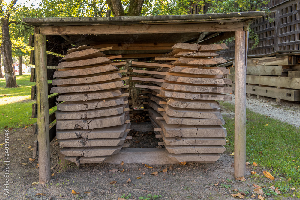 Wooden boards sawn from a log are piled up to dry. Concept: sawmill or woodworking Wooden boards sawn from a log are piled up to dry. Concept: sawmill or woodworking
