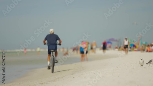 Florida Beach with people lifeguard houses umbrellas afternoon lighting american flag calm ocean 101
