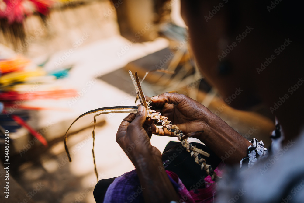 woman weaving banana leaves in Uganda, Africa
