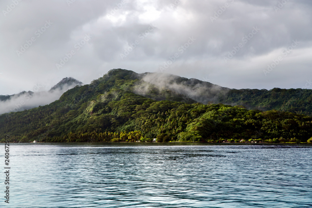Rainforests on the mountains in the misty clouds of the island Moorea in the Leeward group of the Society Islands of French Polynesia.