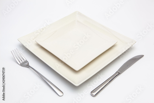 White square plate on the white wooden table.