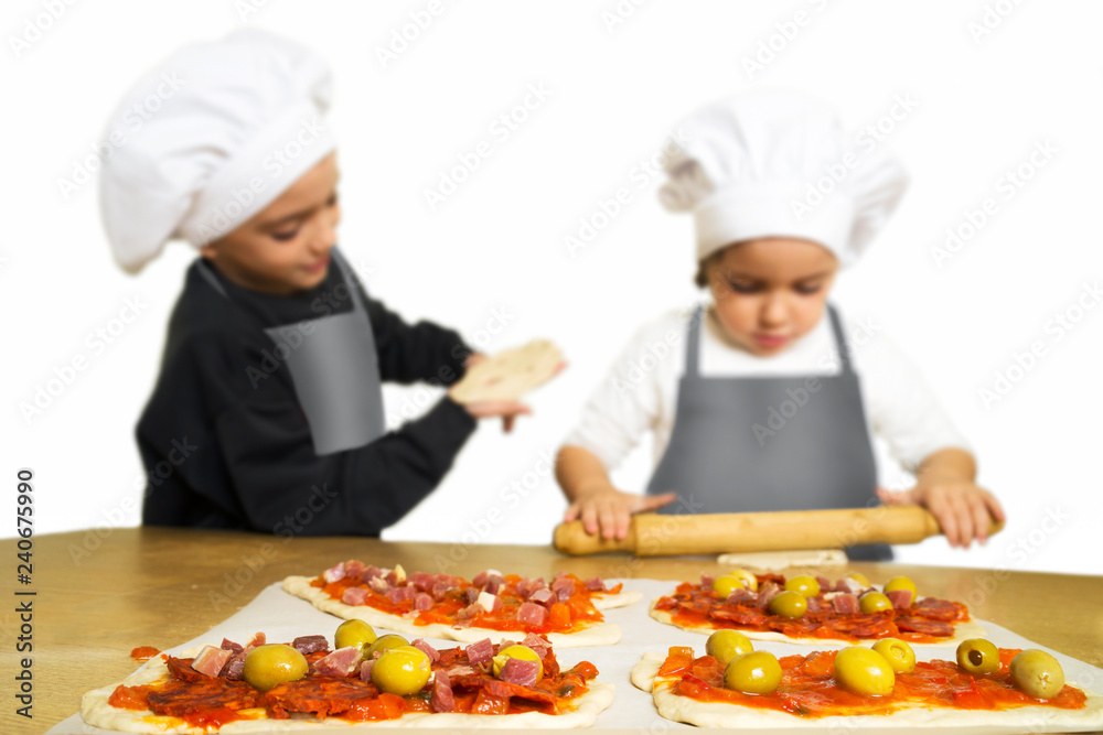 funny happy caucasian girl and boy preparing pizzas to baking in kitchen funny happy caucasian girl and boy preparing pizzas to baking in kitchen