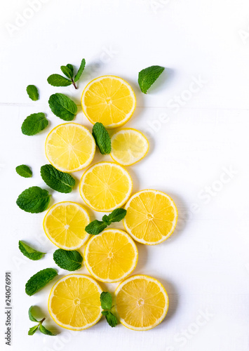 White background with lemon, orange slices and mint. Concept with fresh fruit. Lemon, Orange, Mint. View from above.