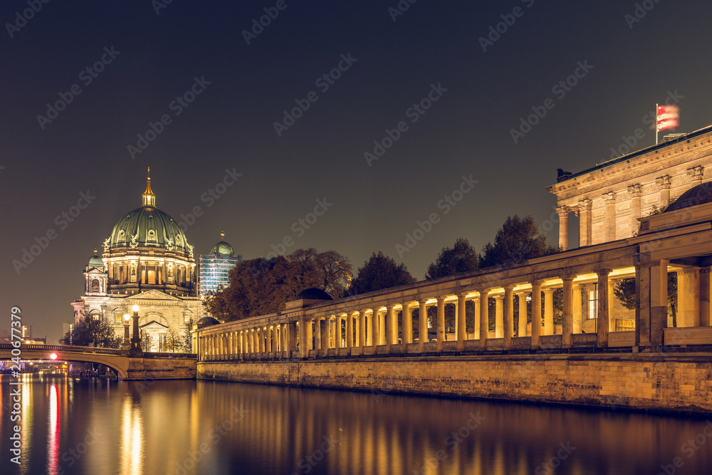 Berlin at night. Berlin Cathedral and the Friedrich's Bridge with lighting and reflections in the river Spree. illuminated arcade of the national gallery in autumn mood