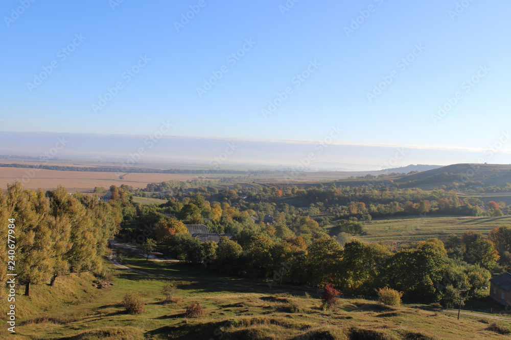 Wonderful panoramic landscape view of on hills with a long horizon and beautiful blue sky