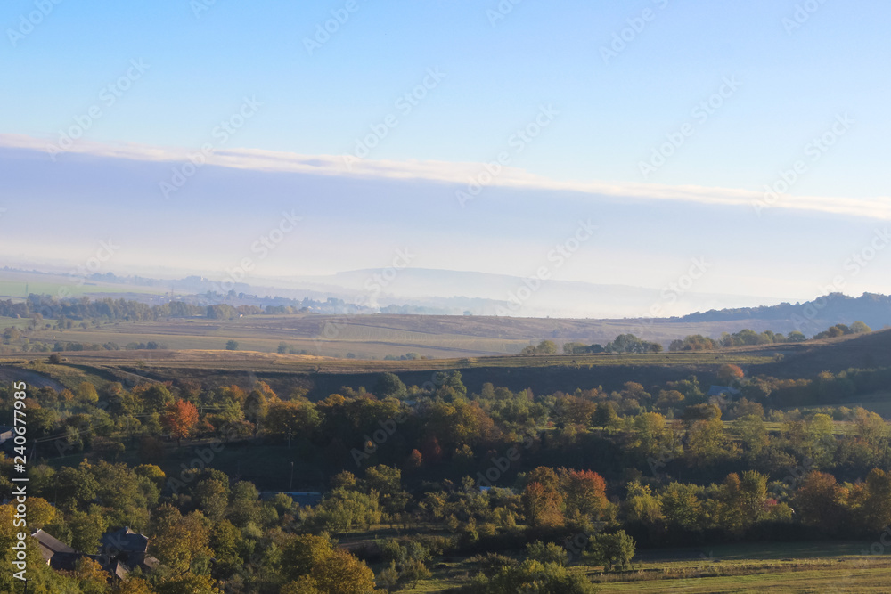 Wonderful panoramic landscape view of on hills with a long horizon and beautiful blue sky