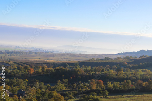 Wonderful panoramic landscape view of on hills with a long horizon and beautiful blue sky