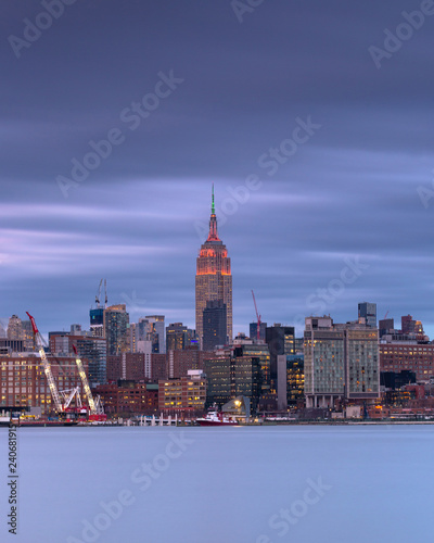 View on Empire state building from hudson river at night with long exposure