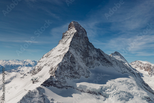 Aerial view of majestic Matterhorn mountain in front of a blue sky. © A. Emson