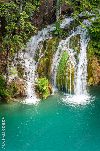 Waterfall at a turquoise lake. The Plitvice Lakes National Park  Croatia  Europe.