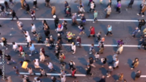 Top view of people walking. Crowd of people on street. Defocused footage. photo
