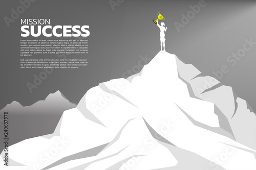 silhouette of businesswomen with the winner trophy standing on the top of mountain. Concept of Goal, Mission, Vision, Success in Career path.