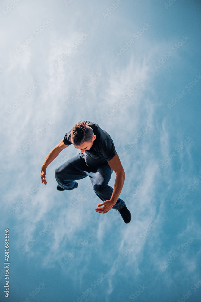 Obraz premium Parkour man in action while doing parkour tricks
