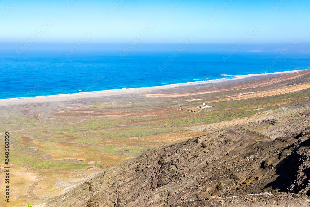 Hiking on Jandia Peninsula, Fuerteventura island, Canary Islands, Spain. Cofete Beach (Playa de Cofete) on the background. Fuerteventura is classic desert island, the oldest island of Canary Islands