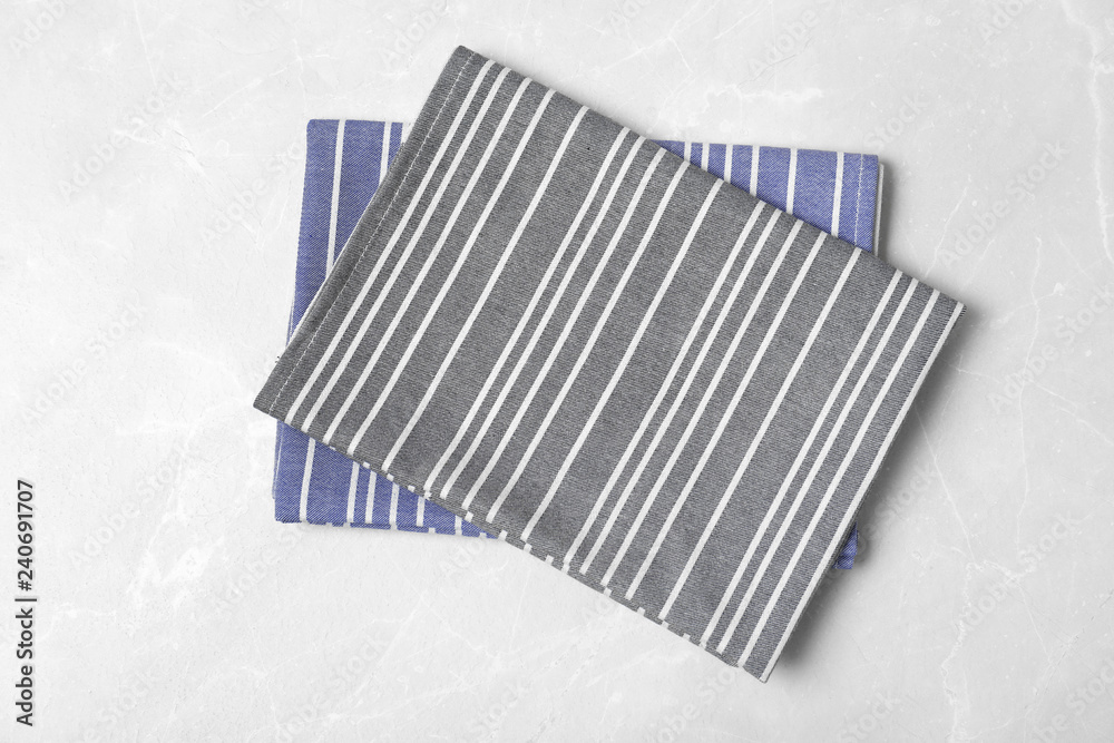 Striped fabric table napkins on light background, top view